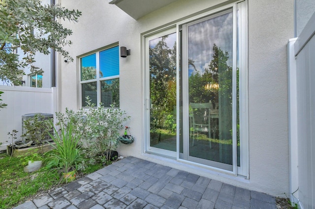 view of exterior entry featuring a patio area