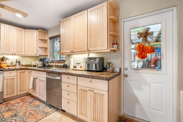 kitchen with light brown cabinets, stainless steel dishwasher, plenty of natural light, and sink