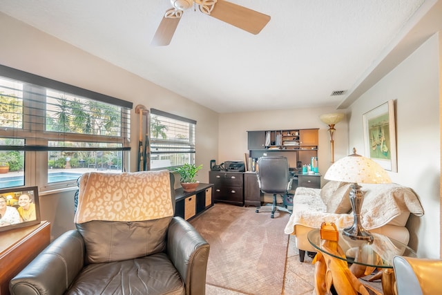 home office with light carpet and ceiling fan