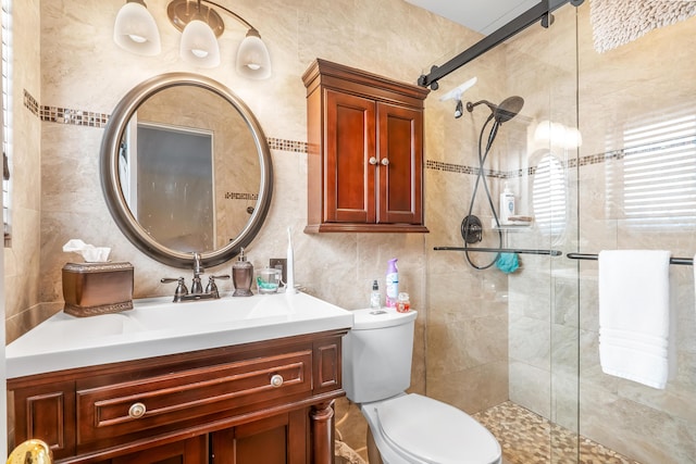 bathroom with vanity, a shower with shower door, and toilet