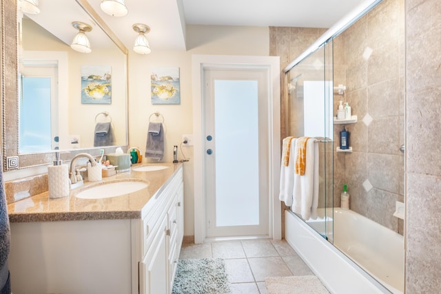 bathroom with combined bath / shower with glass door, vanity, and tile patterned floors