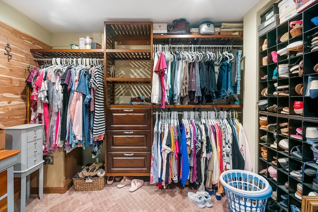 walk in closet with carpet