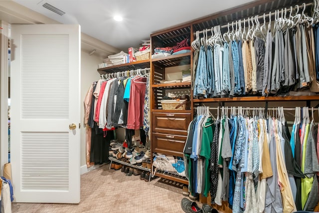 walk in closet with carpet