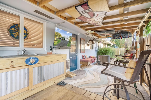 view of patio with cooling unit and sink