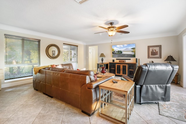 living room featuring light tile patterned floors, a textured ceiling, a wealth of natural light, and ceiling fan