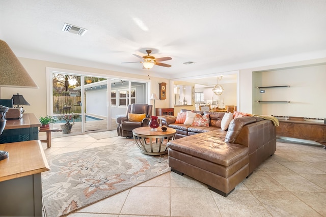 tiled living room with ceiling fan