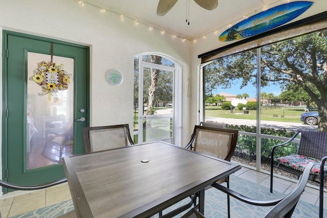 sunroom featuring a ceiling fan