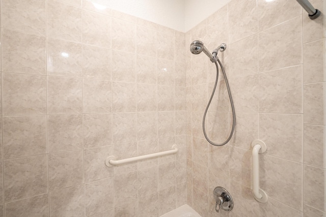 full bath with a tile shower