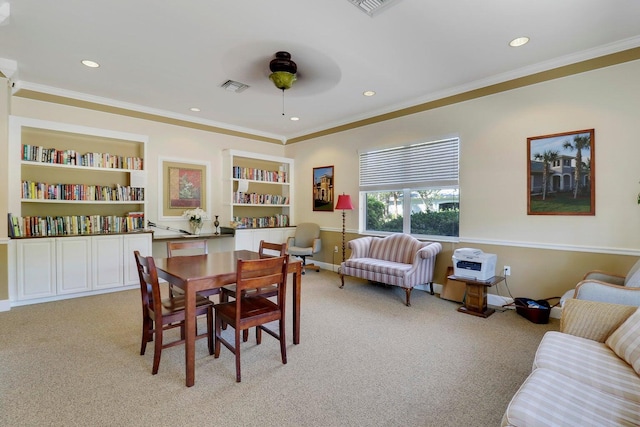 dining space with light carpet, visible vents, ceiling fan, and ornamental molding