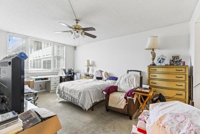 bedroom with carpet flooring, ceiling fan, and a textured ceiling