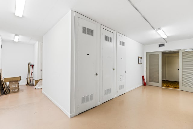 hall with concrete flooring