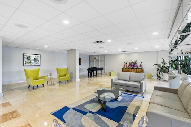 living room featuring a paneled ceiling