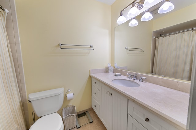 bathroom featuring tile patterned flooring, a shower with curtain, vanity, and toilet