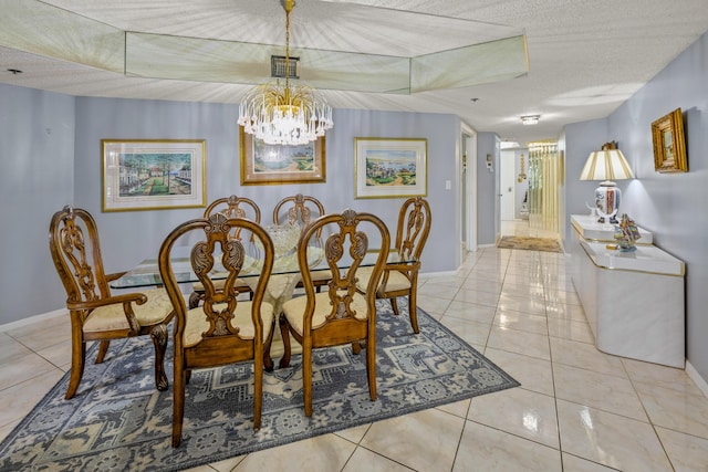 tiled dining space with a textured ceiling and an inviting chandelier