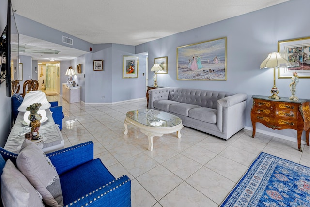 living room featuring light tile patterned flooring and a textured ceiling