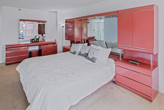 bedroom featuring light colored carpet and a closet