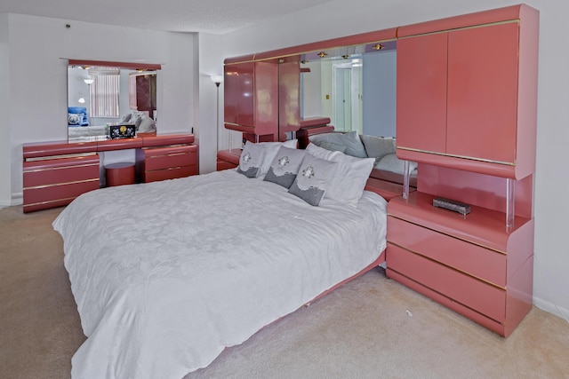 bedroom featuring light carpet and a closet