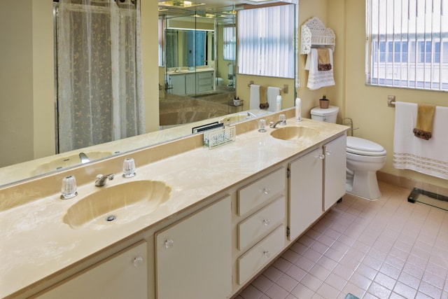 bathroom featuring toilet, vanity, and tile patterned floors