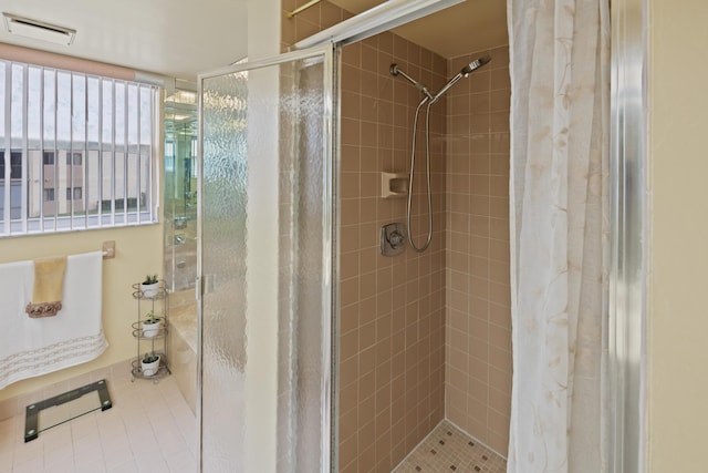 bathroom with a shower with curtain and tile patterned floors