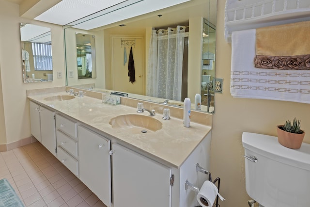 bathroom with tile patterned floors, vanity, and toilet