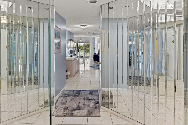 interior space with light tile patterned floors and a textured ceiling