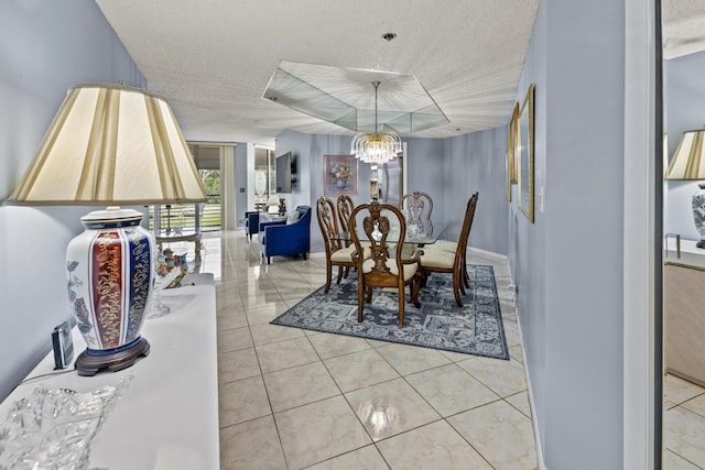 dining room featuring light tile patterned floors, a textured ceiling, and an inviting chandelier