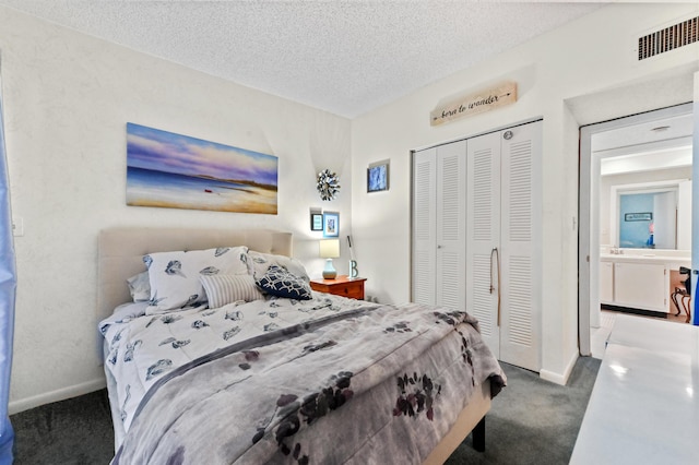 carpeted bedroom with a textured ceiling and a closet