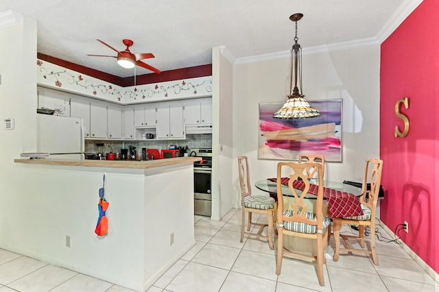 kitchen featuring backsplash, crown molding, white refrigerator, decorative light fixtures, and stainless steel electric range oven