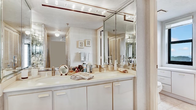 bathroom featuring tile patterned floors, vanity, and toilet