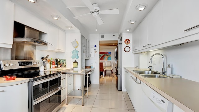 kitchen featuring white cabinetry, sink, stainless steel appliances, and wall chimney range hood