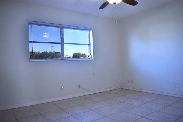 empty room with light tile patterned floors and ceiling fan