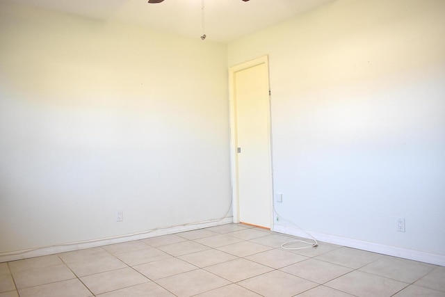 tiled empty room with ceiling fan