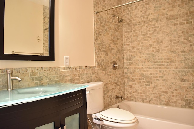 full bathroom with vanity, toilet, and tiled shower / bath