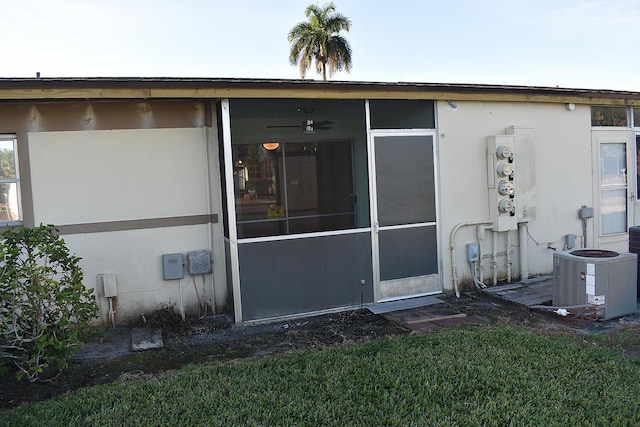 rear view of house with a sunroom and central air condition unit