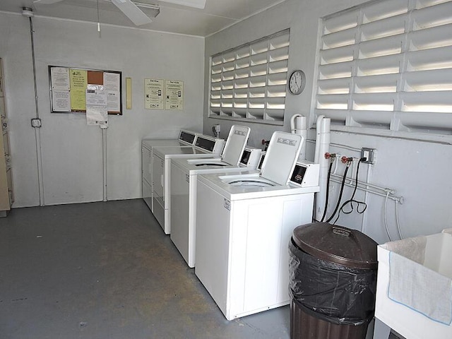 laundry area with washing machine and dryer, ceiling fan, and sink