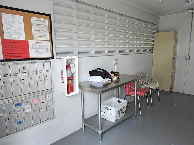 interior space with concrete flooring and a mail area