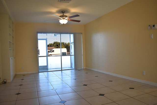 spare room featuring light tile patterned floors and ceiling fan