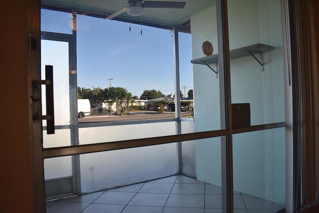 unfurnished sunroom with ceiling fan and a healthy amount of sunlight