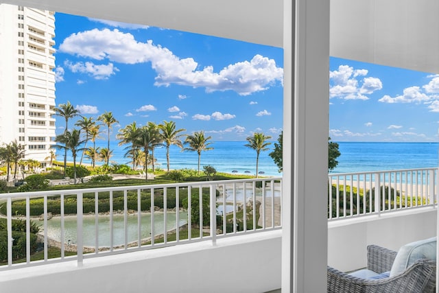 balcony with a view of the beach and a water view