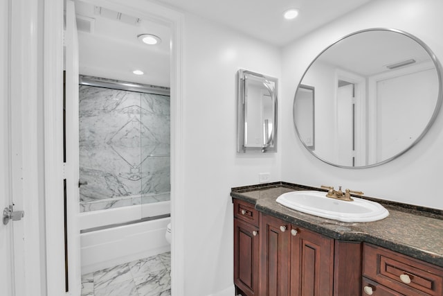 full bathroom with shower / bath combination with glass door, vanity, and toilet