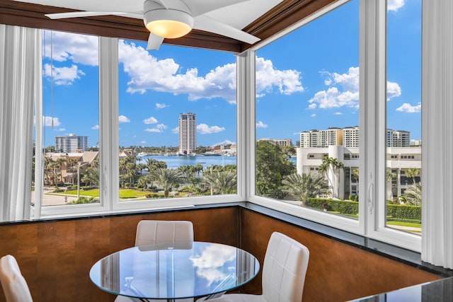 sunroom / solarium featuring a water view and a wealth of natural light