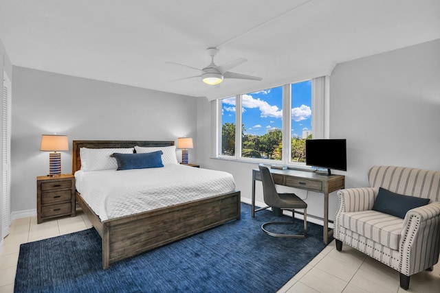 tiled bedroom featuring ceiling fan