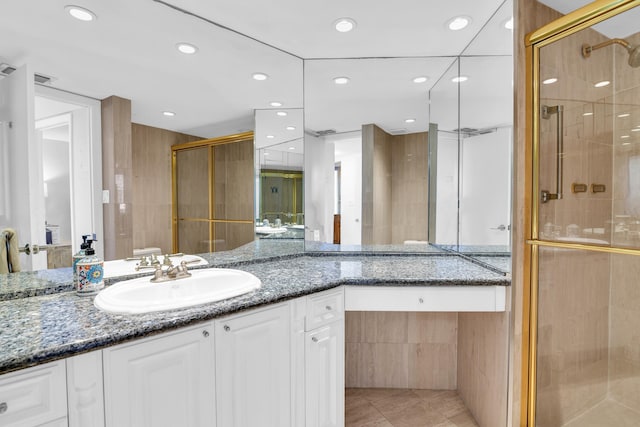 bathroom featuring vanity, tile patterned floors, and an enclosed shower