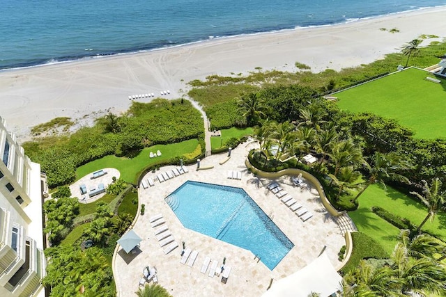 drone / aerial view featuring a beach view and a water view