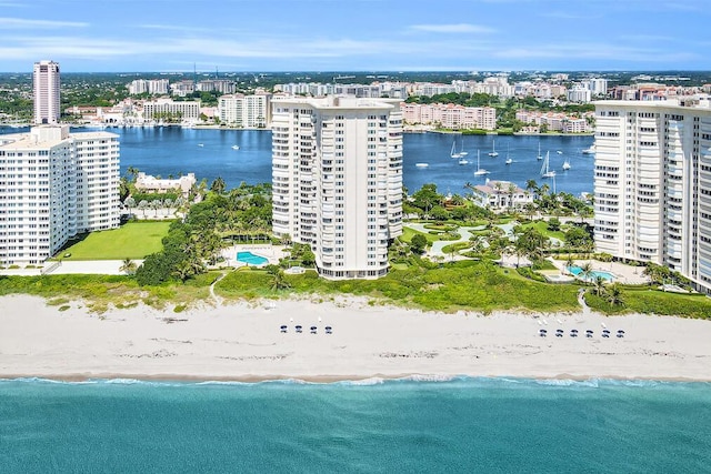 drone / aerial view featuring a water view and a beach view