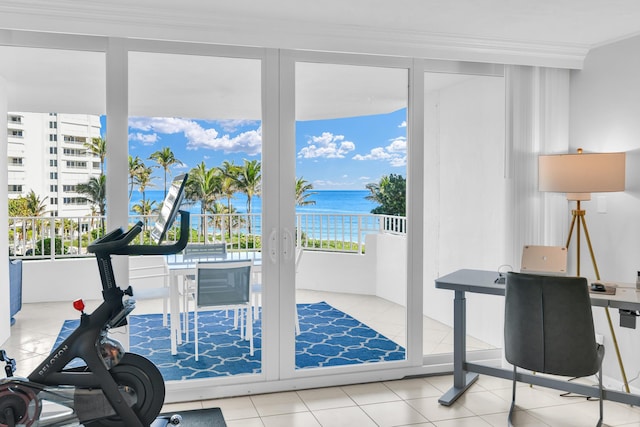 office space featuring tile patterned flooring, a water view, and crown molding