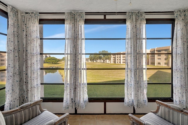 unfurnished sunroom featuring a water view and a wealth of natural light