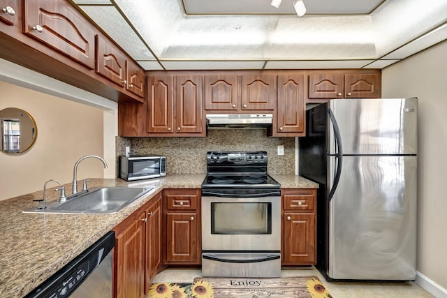 kitchen featuring light tile patterned flooring, sink, stainless steel appliances, and tasteful backsplash