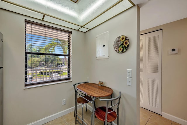 tiled dining room with electric panel