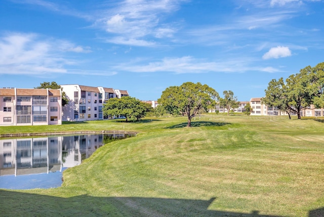 view of community featuring a water view and a lawn